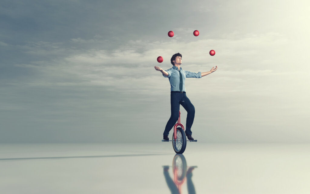 A juggler balancing on a unicycle